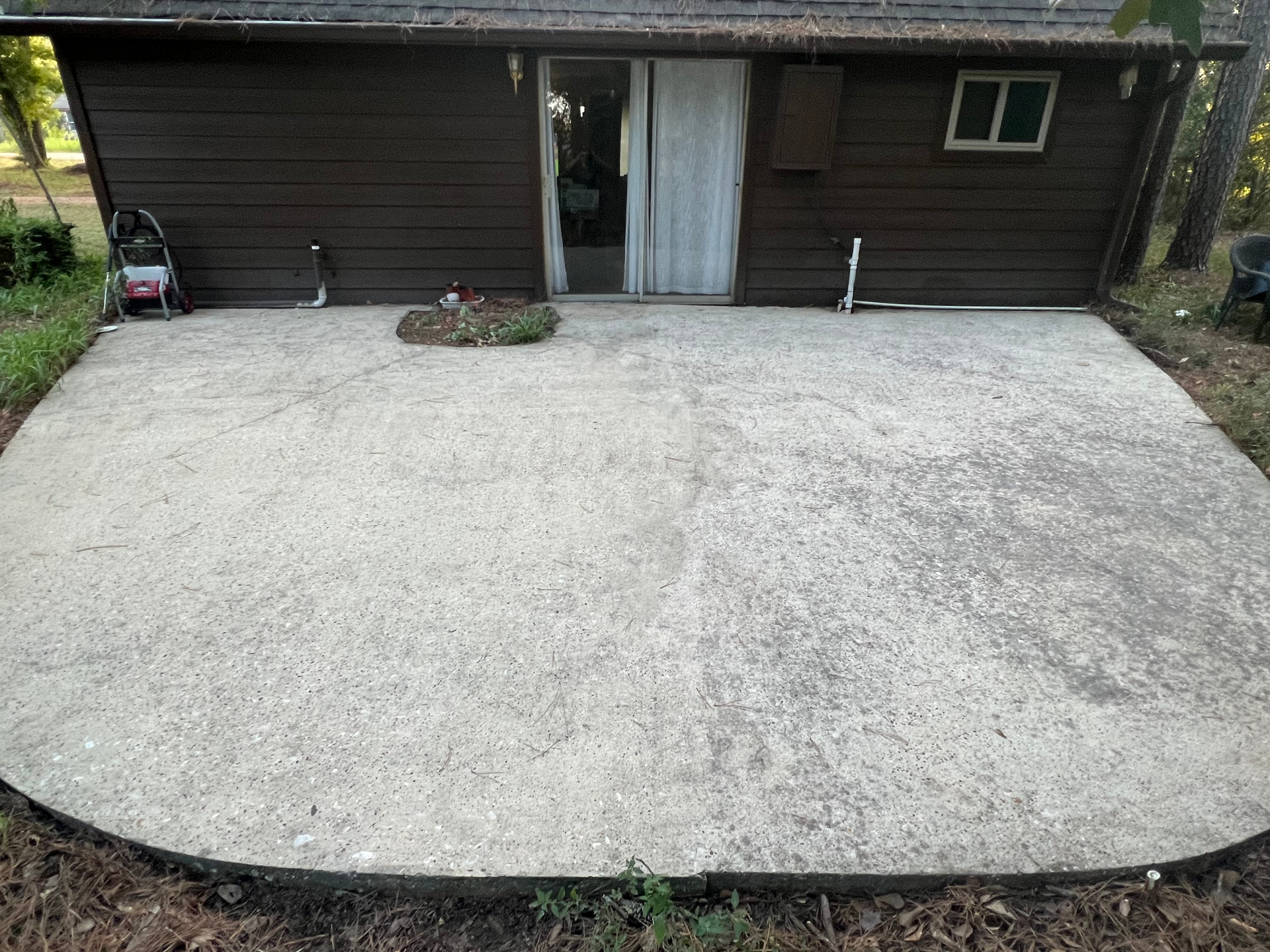 Patio after cleaning, left half single-coat sealed, right half unsealed control with double-coat test square