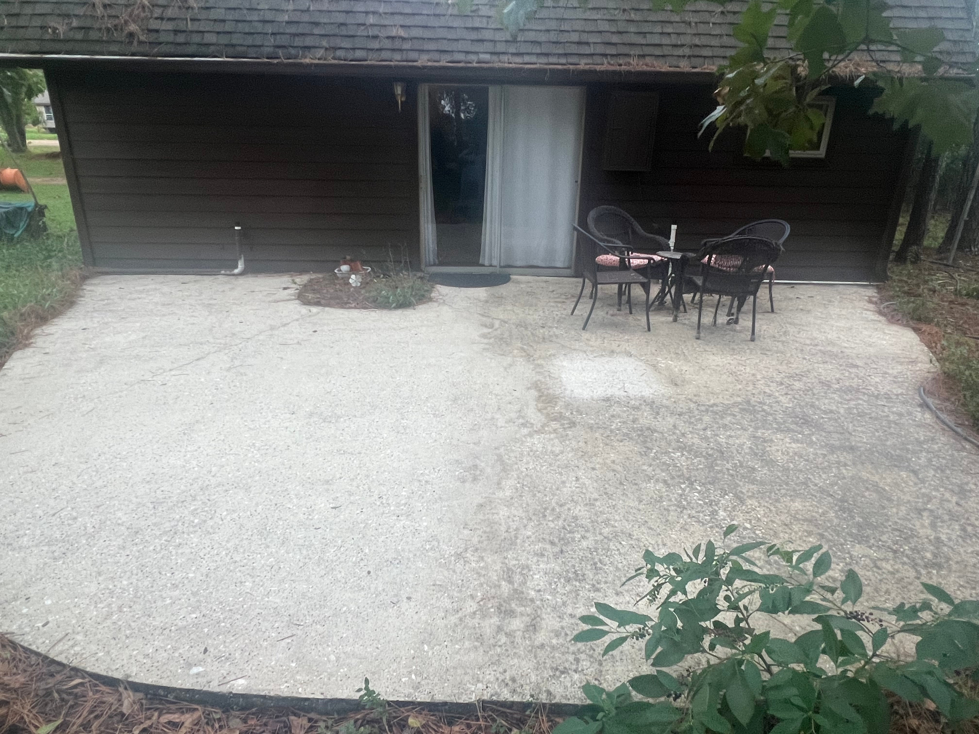 Patio at three months, sealed half clean, unsealed half darkening